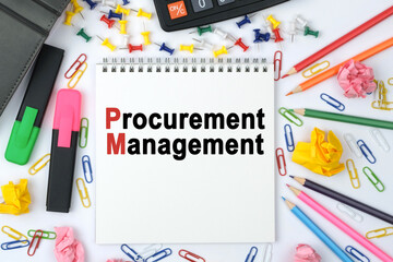 On the table is a calculator, diary, markers, pencils and a notebook with the inscription - Procurement Management