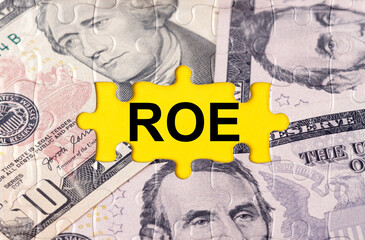 Puzzle with the image of dollars in the center of the inscription -ROE