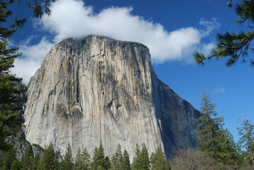 View of El Capitan in Yosemite National Park on a beautiful Spring day when a cloud touched the very top of the monolith rock formation