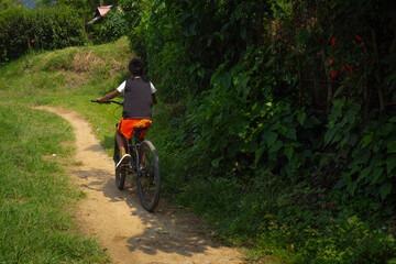 Amaga, Antioquia / Colombia. March 31, 2019. Boy taking bicycle in nature