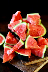 Lots of watermelon wedges on a wooden surface. Selective focus. Macro.