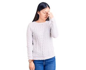 Fototapeta premium Young beautiful chinese woman wearing casual sweater tired rubbing nose and eyes feeling fatigue and headache. stress and frustration concept.