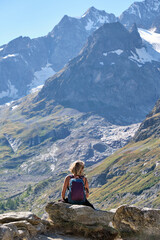 Naklejka na ściany i meble Woman hiker looking the mountains landscape
