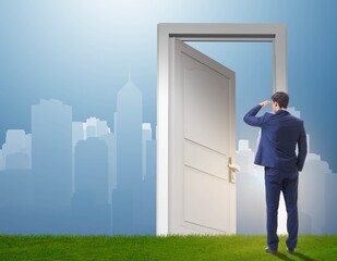 Businessman standing in front of door into future