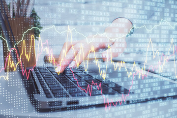 Multi exposure of woman hands typing on computer and forex chart hologram drawing. Stock market analysis concept.