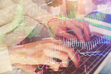 Double exposure of woman hands typing on computer and forex chart hologram drawing. Stock market invest concept.