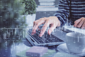 Double exposure of woman hands typing on computer and forex chart hologram drawing. Stock market invest concept.