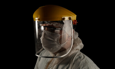 Health worker struggling with the covid-19 virus outbreak. on the dark background.