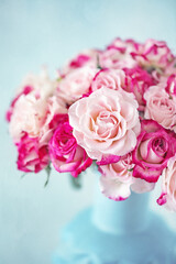 Bright bouquet of a beautiful tea roses in a ceramic jug.Soft focus.