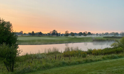 sunrise golf course foggy pond tree reflections