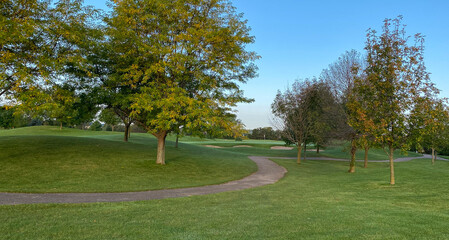 early morning on golf course late summer early autumn green cart path