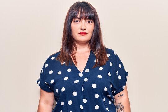 Young plus size woman wearing casual clothes with serious expression on face. simple and natural looking at the camera.