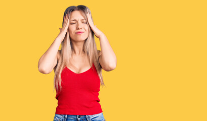 Young beautiful blonde woman wearing casual clothes suffering from headache desperate and stressed because pain and migraine. hands on head.