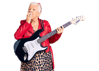 Senior beautiful woman with blue eyes and grey hair wearing a modern look playing electric guitar bored yawning tired covering mouth with hand. restless and sleepiness.