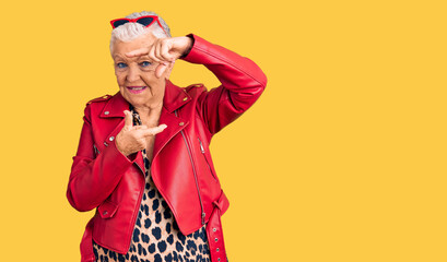 Senior beautiful woman with blue eyes and grey hair wearing a modern style with a red leather jacket smiling making frame with hands and fingers with happy face. creativity and photography concept.