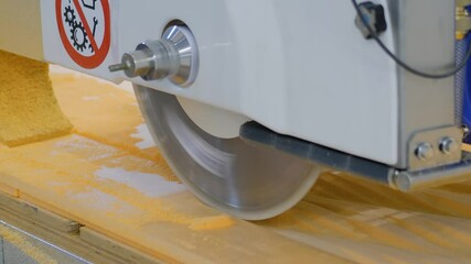 Close up: automatic cnc 5 axis bridge circular saw - router profiling system cutting artificial stone at factory, exhibition. Industry, technology, production, equipment concept