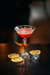 alcoholic cocktail in a glass on a black background in the bar