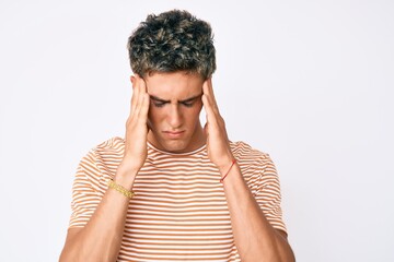 Young handsome man wearing casual clothes with hand on head for pain in head because stress. suffering migraine.