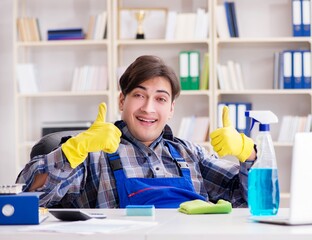 Male cleaner working in the office