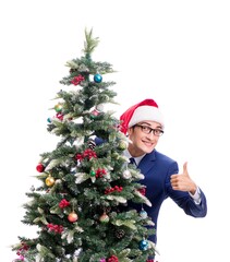 Businessman decorating christmas tree isolated on white