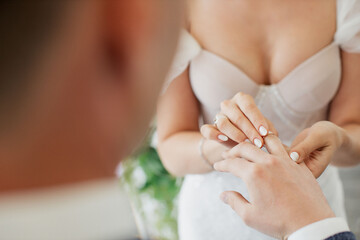 Obraz na płótnie Canvas wedding, putting on a ring by the bride to the groom