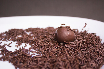 Chocolate granulated is poured. Homemade brazilian sweets. Brigadeiro, Portuguese for 