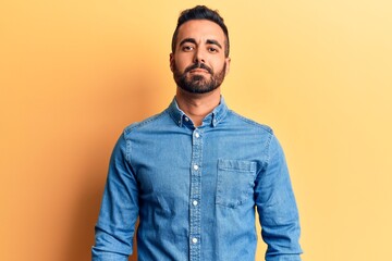 Young hispanic man wearing casual clothes relaxed with serious expression on face. simple and natural looking at the camera.