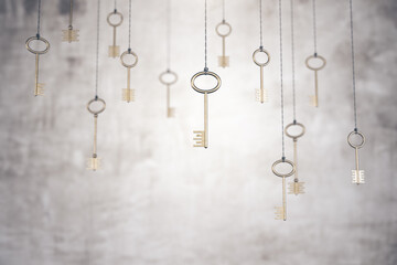 Fototapeta na wymiar Gold keys on rope on blurry concrete wall background.