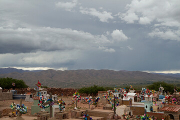 Culture and religion. Indigenous cemetery. Ancient aboriginal graveyard in the desert and mountains under a stormy sky.