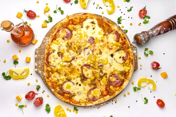 Delicious pizza with sausage, corn, minced meat on wooden plate
