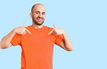Young handsome man wering casual t shirt looking confident with smile on face, pointing oneself...