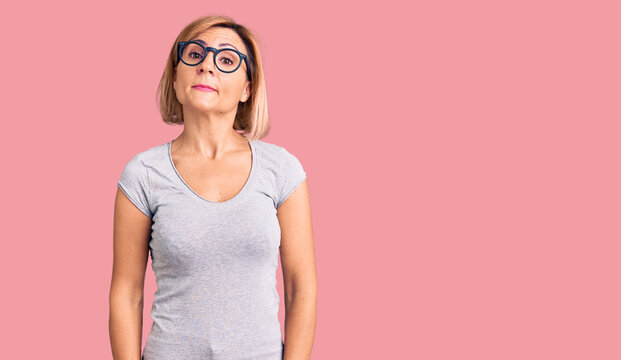 Young blonde woman wearing casual clothes relaxed with serious expression on face. simple and natural looking at the camera.