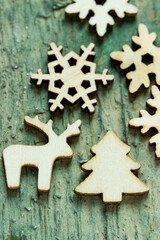 Christmas figurines made of wood on a wooden background.