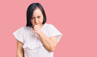 Brunette woman with down syndrome wearing casual white tshirt feeling unwell and coughing as symptom for cold or bronchitis. health care concept.