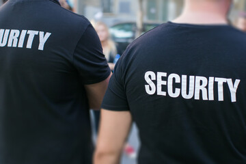 two security guards standing on street