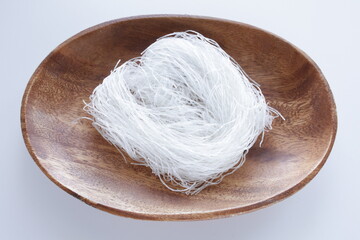 Chinese food ingredient, dried glass noodles on wooden plate