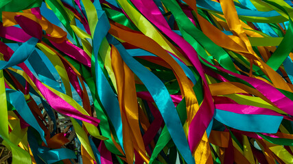 festive colorful background where long multi-colored ribbons flutter in the wind.