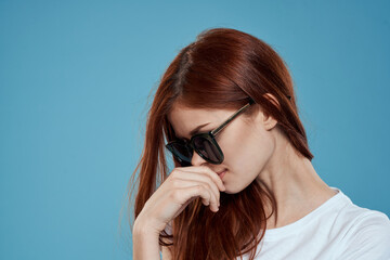 Pretty woman in sunglasses charm long hair white t-shirt blue background