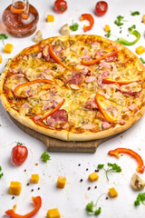 Delicious pizza with sausage, mushrooms, bell pepper on wooden plate