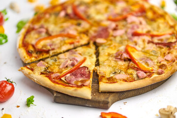 Delicious pizza with sausage, mushrooms, bell pepper on wooden plate