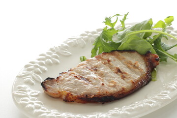 Homemade grilled rice yeast pork served with baby leaves