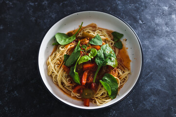 plant-based food, spaghetti with capsicums and tomato sauce with basil