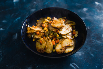 plant-based food, vegan potato bake with garden vegetables and nutritional yeast sauce