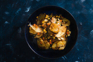 plant-based food, vegan potato bake with garden vegetables and nutritional yeast sauce