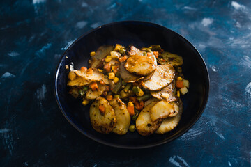 plant-based food, vegan potato bake with garden vegetables and nutritional yeast sauce