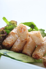 Vietnamese food, deep fried spring roll served with cucumber and salad