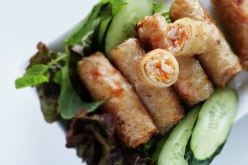 Vietnamese food, deep fried spring roll served with cucumber and salad