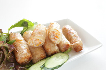 Vietnamese food, deep fried spring roll served with cucumber and salad