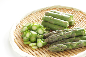 chopped green asparagus on bamboo basket