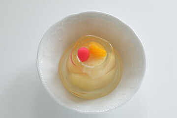Mixed fruit Jelly in bowl on white background with copy space